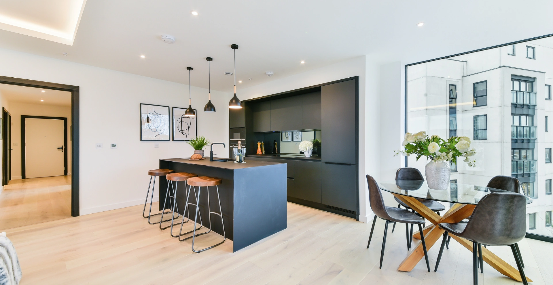 Image of a beautiful home with ambient lights hanging over the kitchen counter installed by Rajvar.